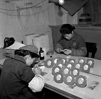 Women making Mao buttons